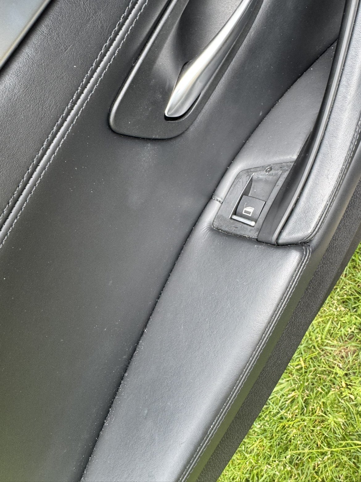 Before: dusty car door interior panel with visible debris around the window switch